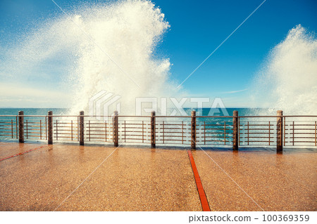 A huge sea wave is breaking on the promenade. The embankment in San Sebastian, Basque Country, Spain, Europe 100369359