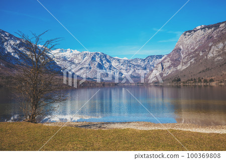 Mountain lake with reflection. Beautiful nature of Bohinj Lake (Bohinjsko jezero), Slovenia, Europe Mountain lake with reflection. Beautiful nature of Bohinj Lake (Bohinjsko jezero), Slovenia, Europe 100369808