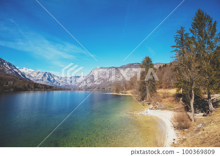 Mountain lake with reflection. Beautiful nature of Bohinj Lake (Bohinjsko jezero), Slovenia, Europe Mountain lake with reflection. Beautiful nature of Bohinj Lake (Bohinjsko jezero), Slovenia, Europe 100369809