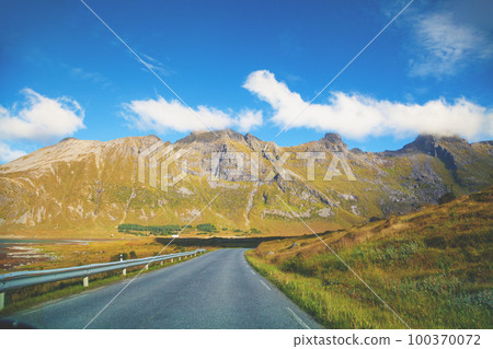 Driving a car on a mountain road in Lofoten islands, view from the windscreen. Norway, Europe 100370072