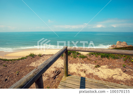 The wooden platform on a rocky seashore on a sunny day. Victory Walls Beach, Portugal, Europe 100370155