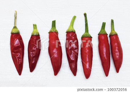 Red Hot Chili Peppers on light wooden background. Copy space for text. Ugly Red Hot Chili Peppers. 100372056