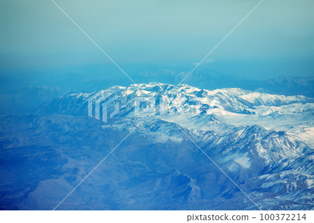 View of the snow-covered mountains from the plane 100372214