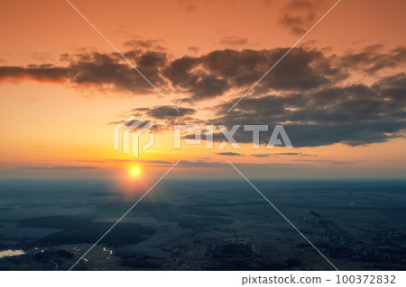 Sunset in the countryside in spring. Rural landscape in the evening. Aerial view of the countryside in evening. Panoramic view Sunset in the countryside in spring. Rural landscape in the evening. Aerial view of the countryside in evening. Panoramic view 100372832