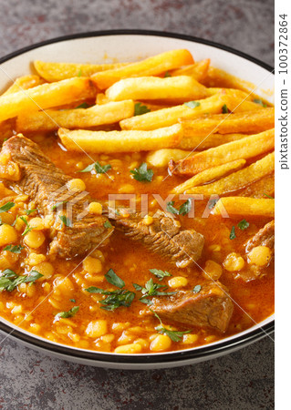Khoresh Gheymeh Beef and yellow split pea stew with roasted potatoes closeup on a plate. Vertical Khoresh Gheymeh Beef and yellow split pea stew with roasted potatoes closeup on a plate. Vertical 100372864