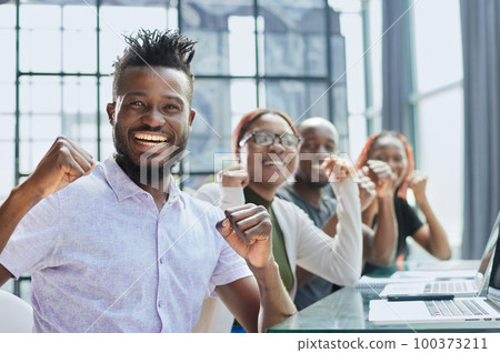 business team celebrating their success. good deal 100373211