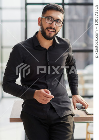 portrait of a young businessman who is smiling portrait of a young businessman who is smiling 100373518