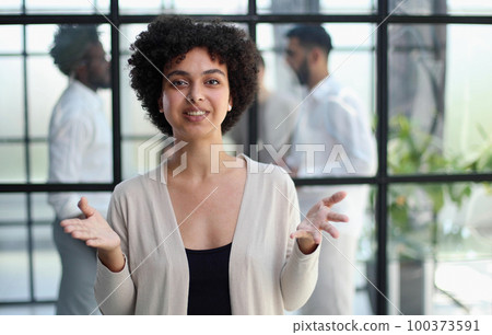 business woman with her staff in background at office business woman with her staff in background at office 100373591