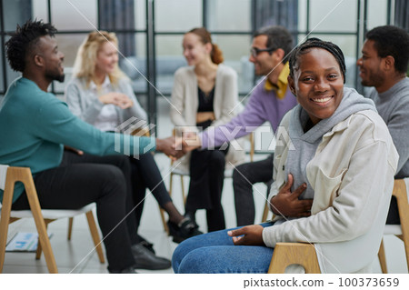 Successful manager or team leader sitting in front of his colleagues Successful manager or team leader sitting in front of his colleagues 100373659