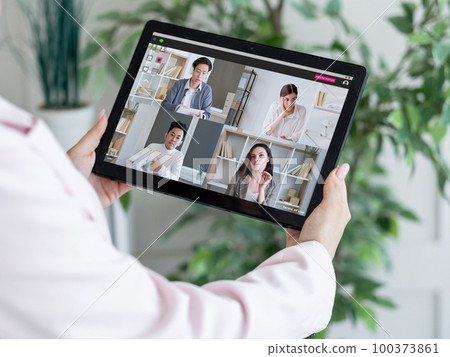 Digital study. Video call. Internet education. Female teacher watching diverse students group learning working online on tablet screen. 100373861