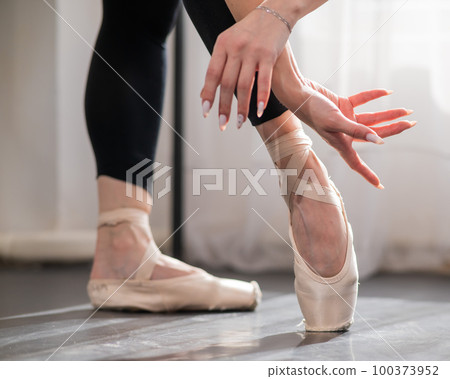 Close-up of the legs and arms of a ballerina. Close-up of the legs and arms of a ballerina. 100373952