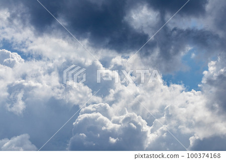 High layered white epic clouds on blue sky High layered white epic clouds on blue sky 100374168