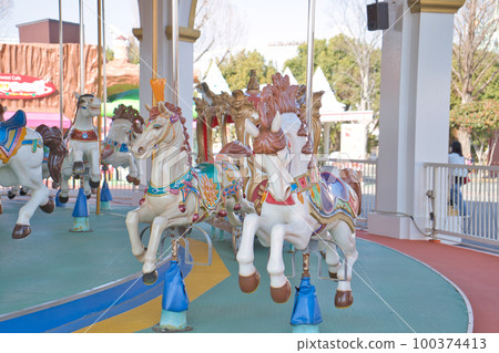 A merry-go-round where you can ride colorful horses A merry-go-round where you can ride colorful horses 100374413