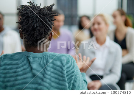 Multi-ethnic group of people in audience at business conference 100374810