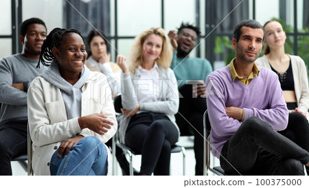 young people shaking hands in a circle of like-minded people 100375000