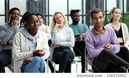 young people shaking hands in a circle of like-minded people 100375001