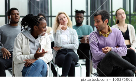 young people shaking hands in a circle of like-minded people 100375002
