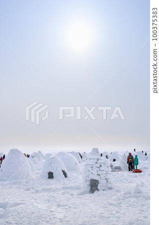Igloos built for contest, traditional shelter of northern peoples from the cold, made of snow bricks Igloos built for contest, traditional shelter of northern peoples from the cold, made of snow bricks 100375383