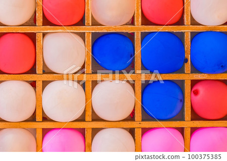 Multicolored bright colorful vibrant balloons background for playing darts game 100375385