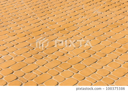 Light orange or yellow stone paving slabs floor tile urban texture background Light orange or yellow stone paving slabs floor tile urban texture background 100375386