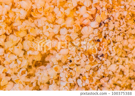 Orange color sweet popcorn, crunchy corn snack background Orange color sweet popcorn, crunchy corn snack background 100375388