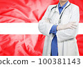 Doctor standing with the flag 100381143