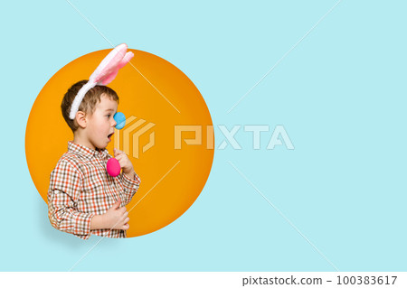 little child boy with Easter bunny ears holding colorful eggs 100383617