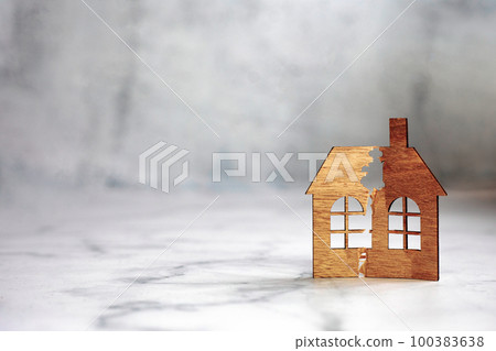 The division of the property. The destruction of the family. A broken house. Divorce and division of property. A symbol of family problems. divorce concept copy space 100383638