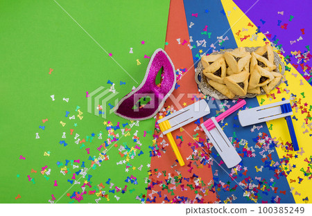 Enjoy eating hamantaschens and celebrating with carnival masks in commemoration saving Jews from Haman evil plan. Enjoy eating hamantaschens and celebrating with carnival masks in commemoration saving Jews from Haman evil plan. 100385249