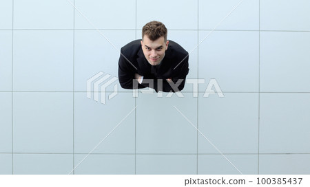 Celebrating success. Low angle view of excited young businessman keeping arms Celebrating success. Low angle view of excited young businessman keeping arms 100385437