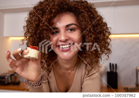 Young woman eating sushi asian food and noodles using choopsticks from take away delivery 100387962