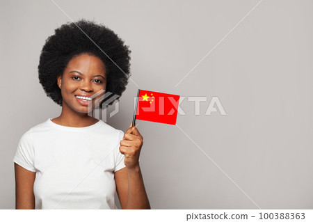 Chinese woman holding flag of China. Education, business, citizenship and patriotism concept 100388363