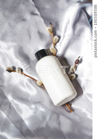 Top view of white jar for cream or other cosmetic products, in soft tissue folds. Top view of white jar for cream or other cosmetic products, in soft tissue folds. 100389386