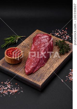 Beautiful fresh piece of raw beef on a wooden cutting board 100390607