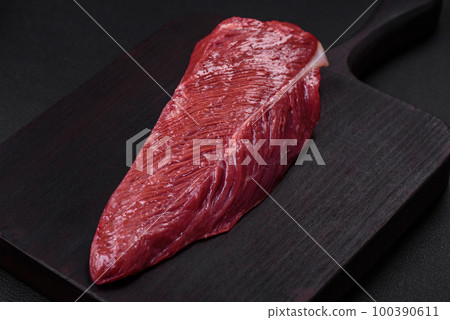 Beautiful fresh piece of raw beef on a wooden cutting board 100390611