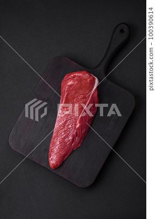 Beautiful fresh piece of raw beef on a wooden cutting board Beautiful fresh piece of raw beef on a wooden cutting board 100390614