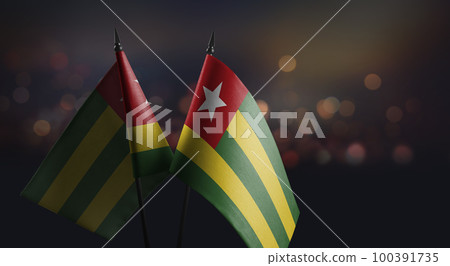 Small flags of the Togo on an abstract blurry background 100391735