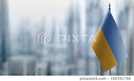 A small Ukraine flag on an abstract blurry background A small Ukraine flag on an abstract blurry background 100391786