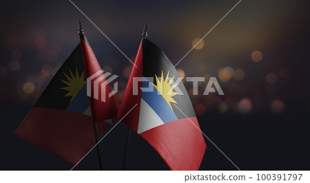 Small flags of the Antigua and Barbuda on an abstract blurry background 100391797