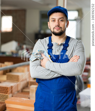 Successful young foreman standing inside building under construction Successful young foreman standing inside building under construction 100392232