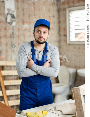 Successful young foreman standing inside building under construction Successful young foreman standing inside building under construction 100392586