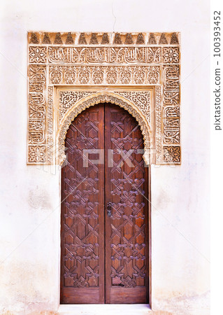 amazing Alhambra palace - unique carved walls and doors in arabian style in Granada, Andalusia, Spain 100393452