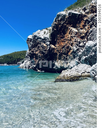 Rocky beach and crystal turquoise water of Ionian Sea in Albania. Rocky beach and crystal turquoise water of Ionian Sea in Albania. 100394016