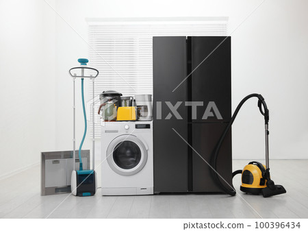 Refrigerator and different household appliances in room Refrigerator and different household appliances in room 100396434