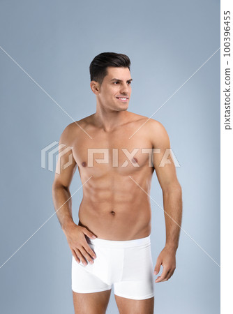 Handsome man in white underwear on light grey background Handsome man in white underwear on light grey background 100396455