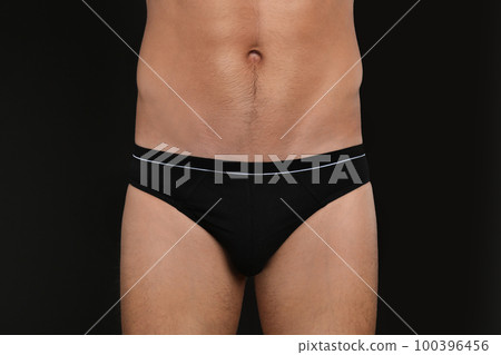 Man in underwear on black background, closeup 100396456