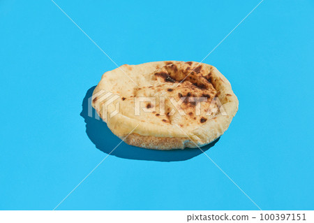 Egyptian bread Aish Baladi. Fresh bread lies on the blue table 100397151