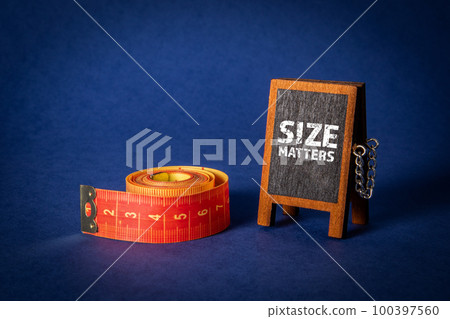 Size Matters. Miniature blackboard with text and measuring tape on a blue background Size Matters. Miniature blackboard with text and measuring tape on a blue background 100397560