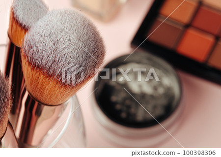 decorative cosmetics on pink background. close up decorative cosmetics on pink background. close up 100398306