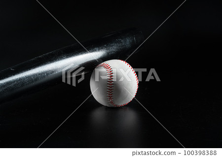 Baseball game equipment on dark black background 100398388